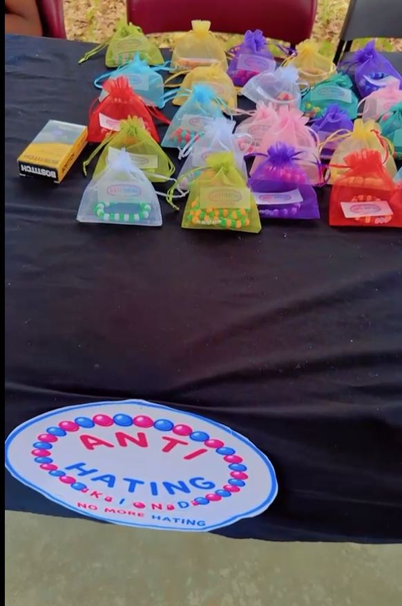 A founder's Market Day booth with visitors and product displays